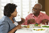 couple sitting at a table, eating a healthy meal together