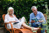 senior couple enjoying reading outside together