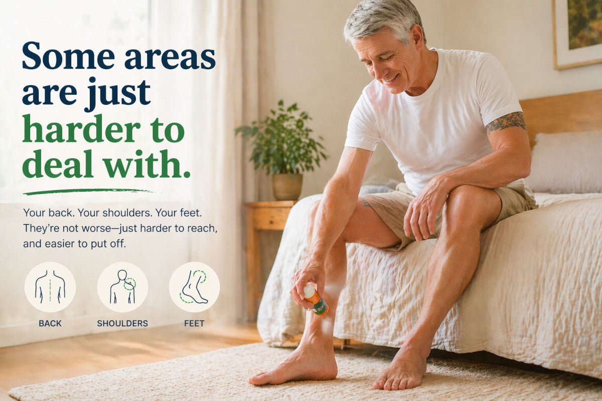 Older man applying spray to his foot in a relaxed bedroom setting