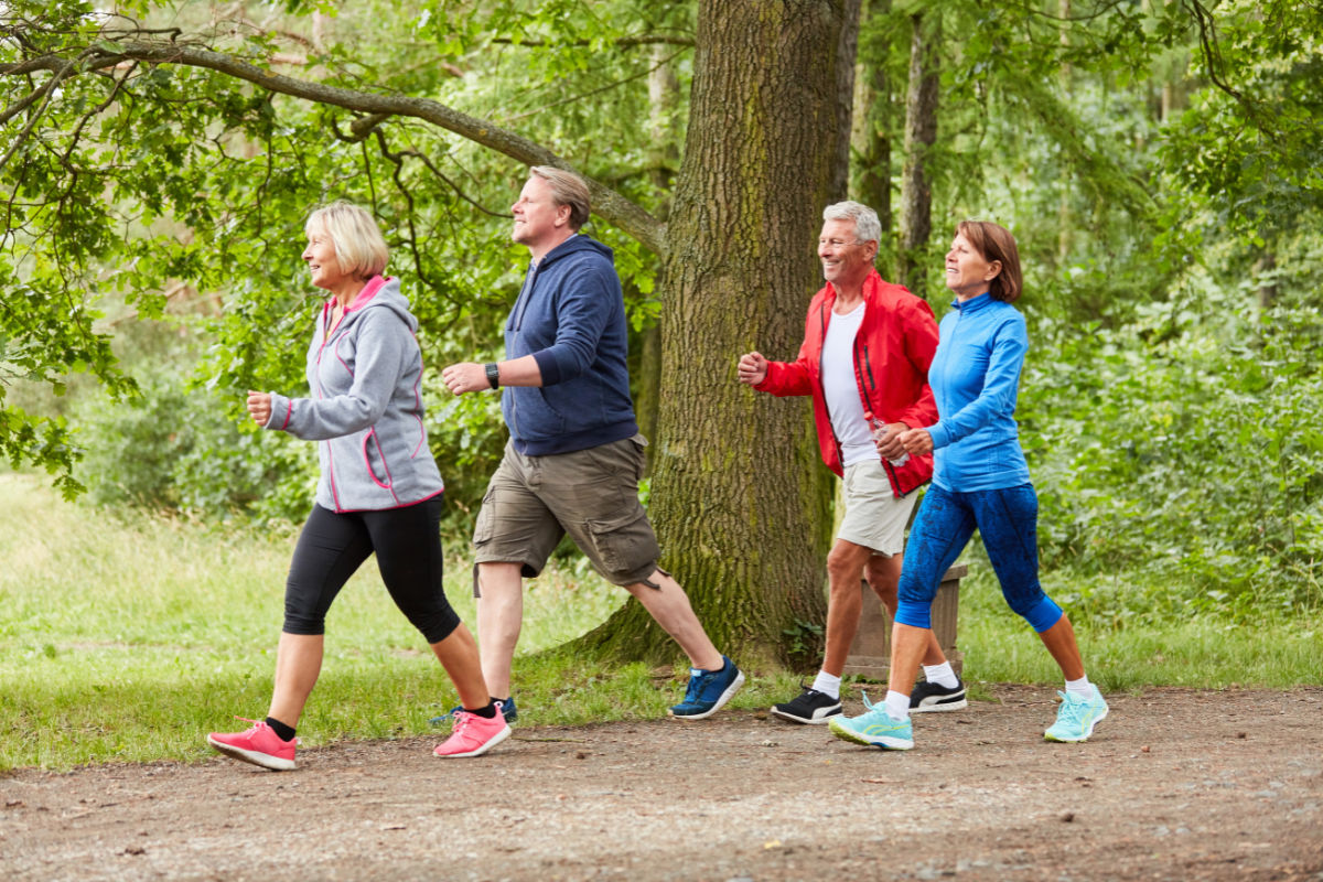 group of seniors walking on a nature trail