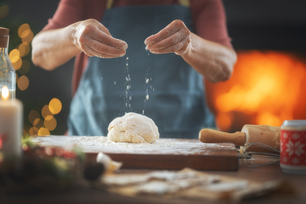 close-up of older woman preparing dough on a cutting board