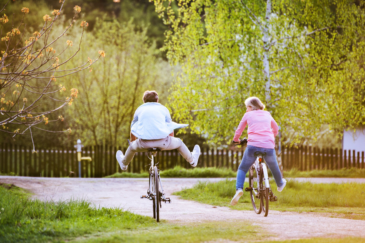 two seniors riding bikes in the warm spring weather.