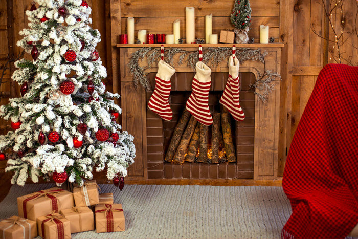 log cabin decorated with Christmas decor, from Christmas stockings hung above the fireplace to a Christmas tree