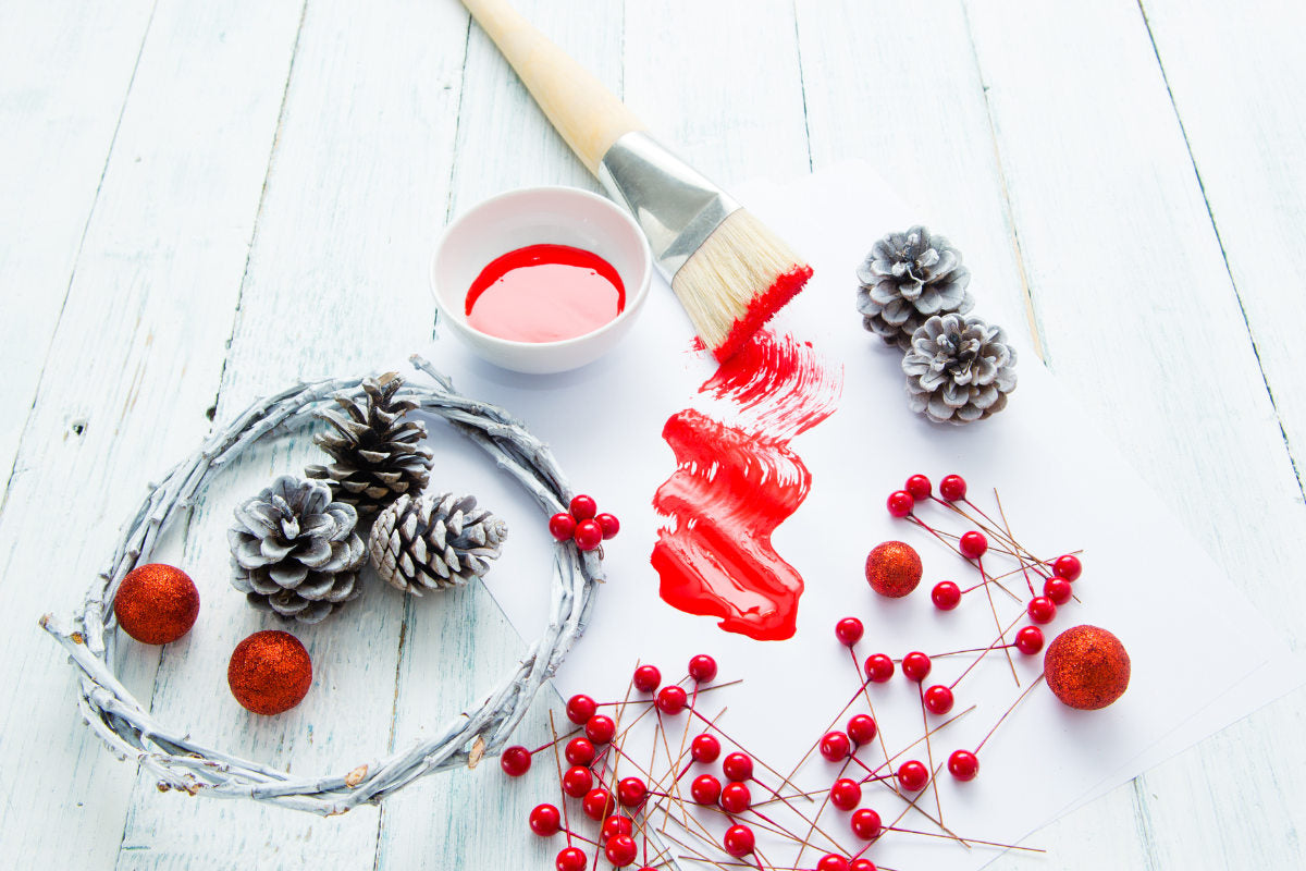 various Christmas decorations laid out on white wooden table
