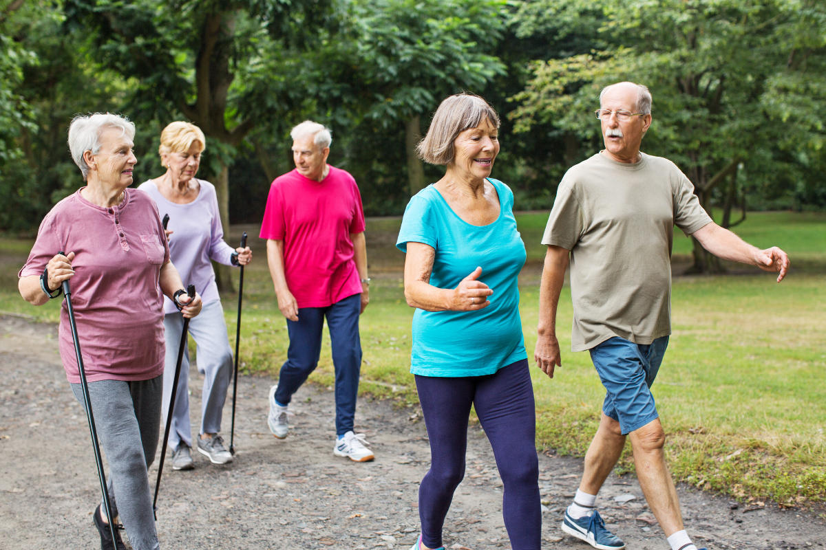 elderly group of people walking outside