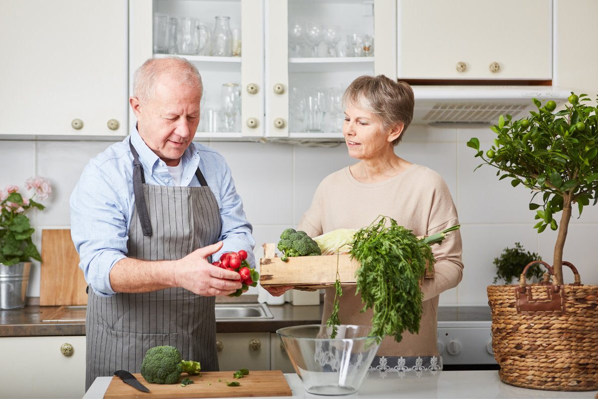 senior couple in the kitchen preparing a meal
