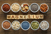 the word magnesium spelled out from letter blocks, surrounded by magnesium-rich foods