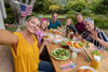 family enjoying food outside and celebrating the 4th of July