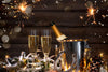 2 glasses of wine sitting on table with New Year's Eve decorations