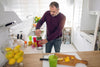 older man making a smoothie in his kitchen