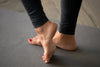 active woman practicing yoga, doing foot exercises (close up on feet)