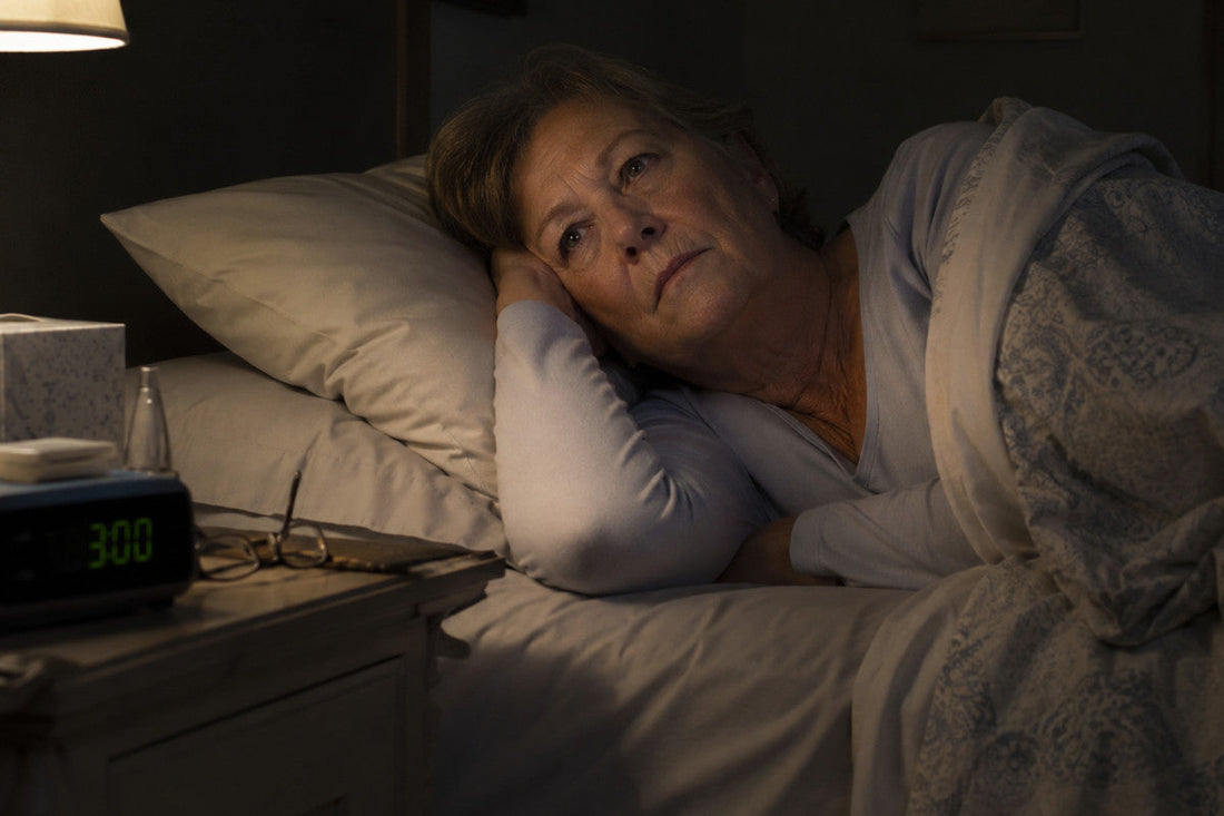 A woman lying awake in bed at night