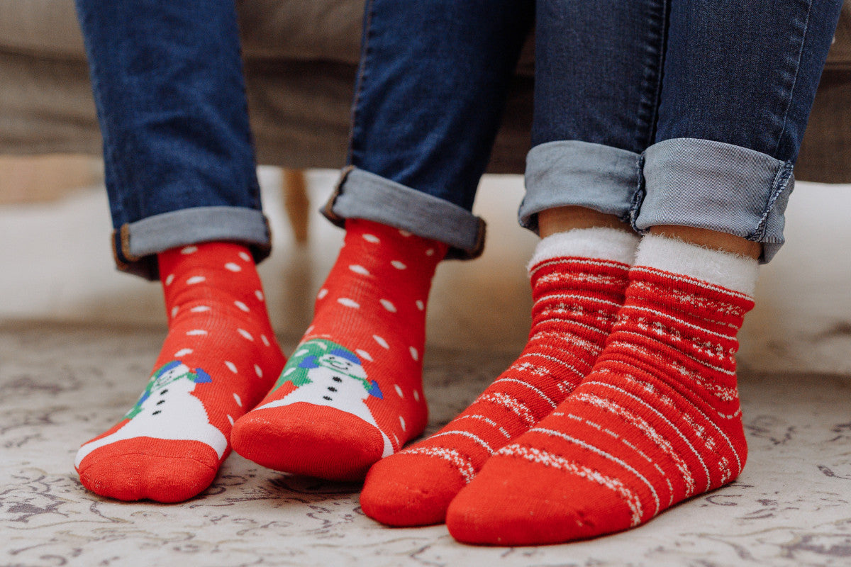 close-up of couple wearing holiday Christmas socks.