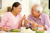 older couple eating healthy and happy together