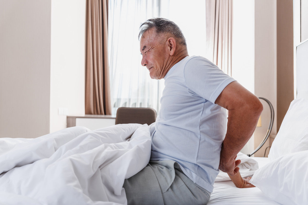 senior man having back pain after sleeping.