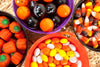 4 different colored buckets filled with Halloween candy
