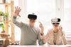 senior couple sitting at table experiencing virtual reality