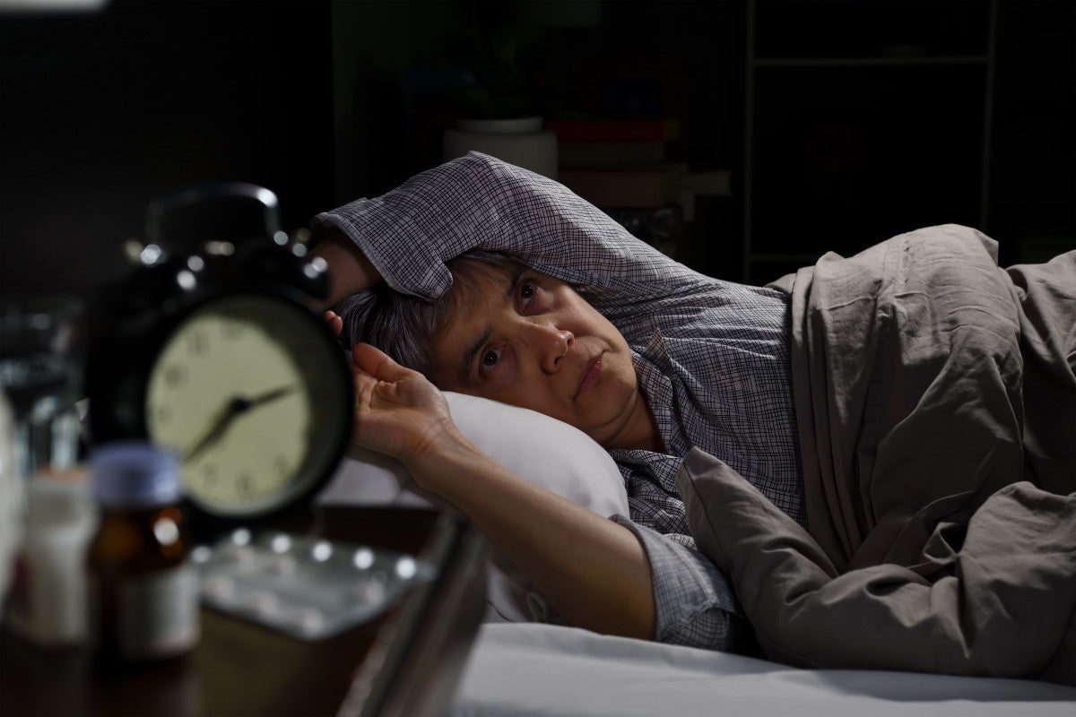Senior woman lying awake at 3am.