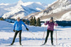 two seniors skiing together in the mountains