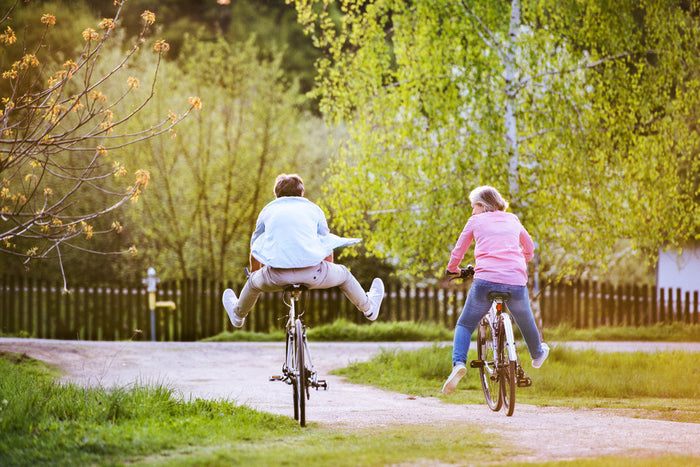 two seniors riding bikes in the warm spring weather.