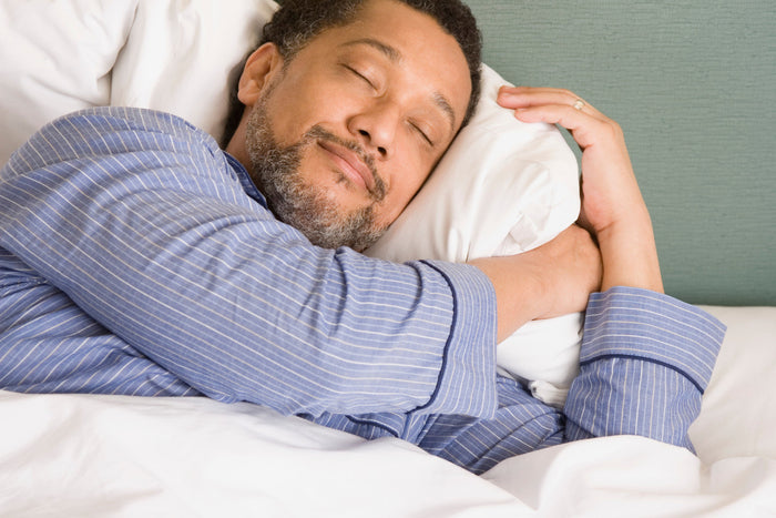 man sleeping peacefully in bed