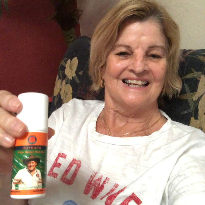 Debra Frohreich, a verified customer, holding the Outback Original roll-on